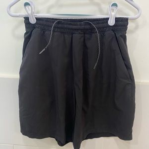 Lululemon men’s size small black Pace Breaker shorts.